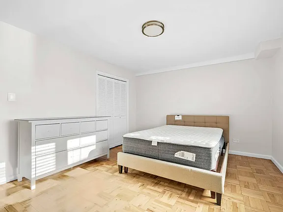 room with bed view of co-op apartment building at 21050 41st Ave Apt 1C in Flushing, NY