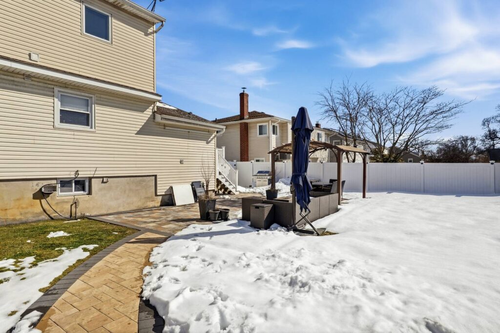 House for Sale in Freeport NY – Outside view in snowfall